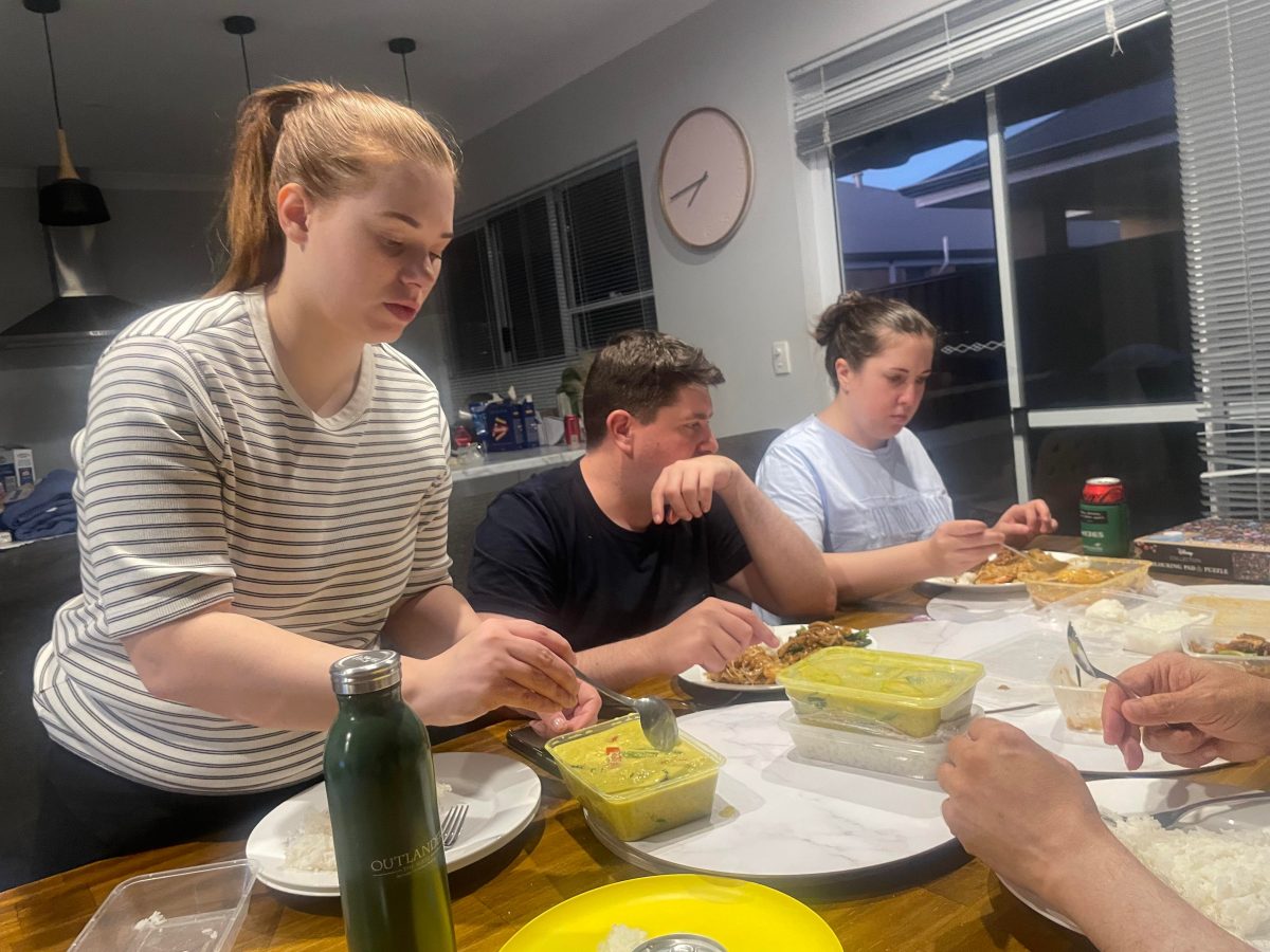 family eating thai food at airbnb