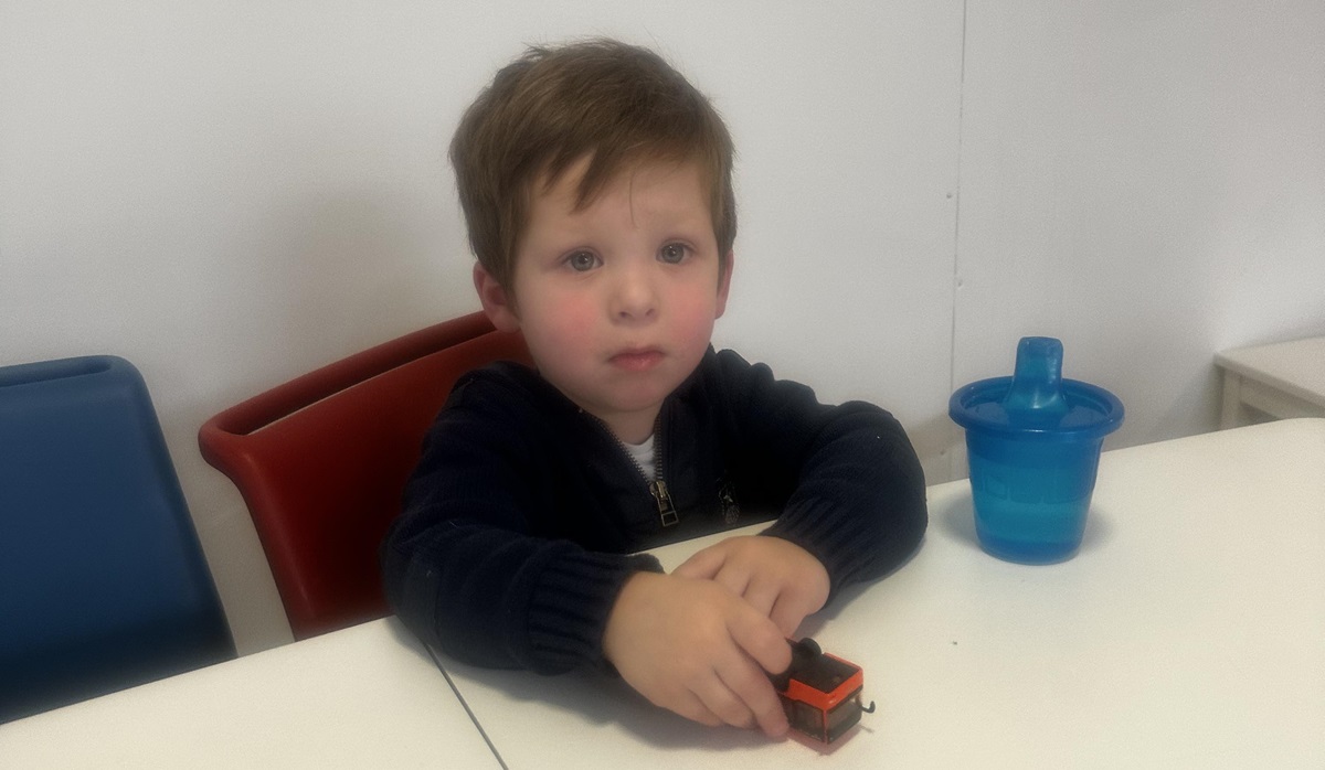 sad little boy with toy train