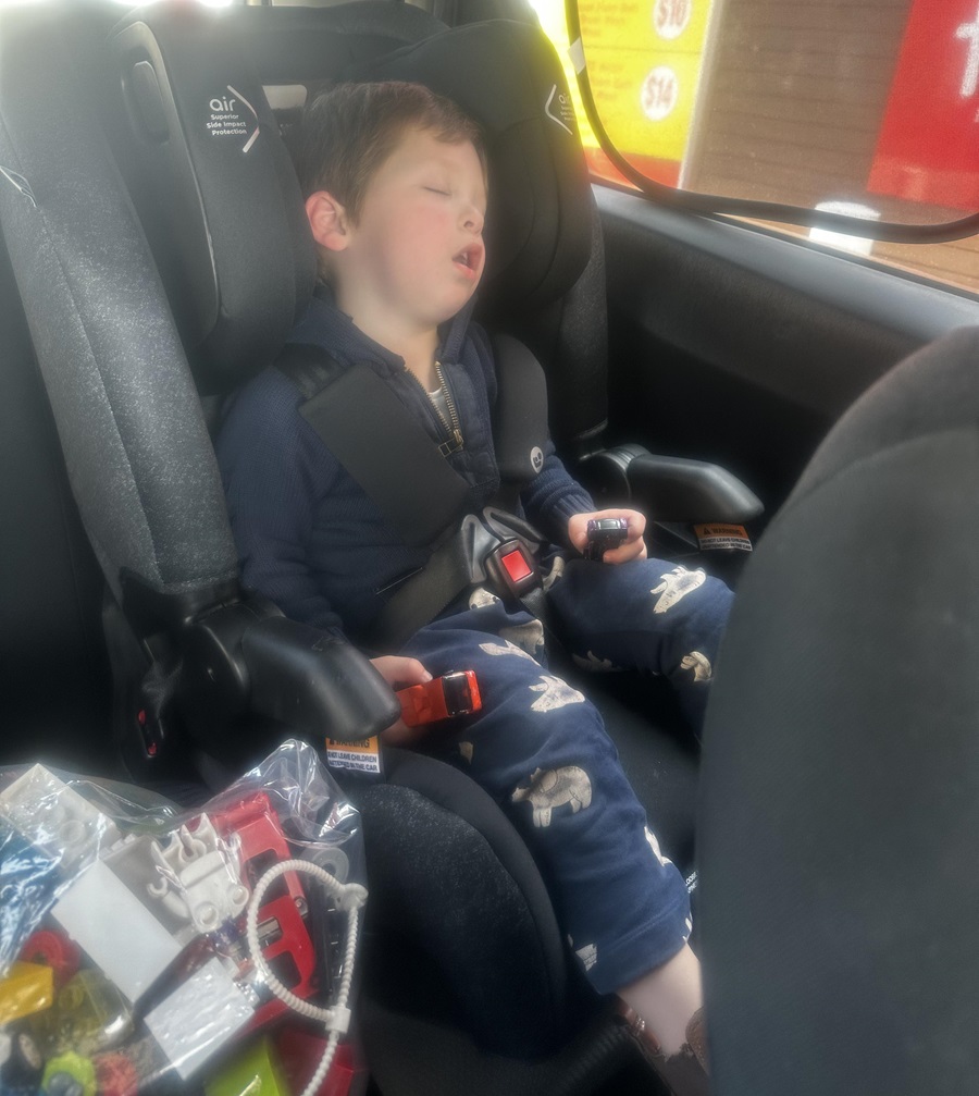 taking a nap in the back of the car outside petrol station