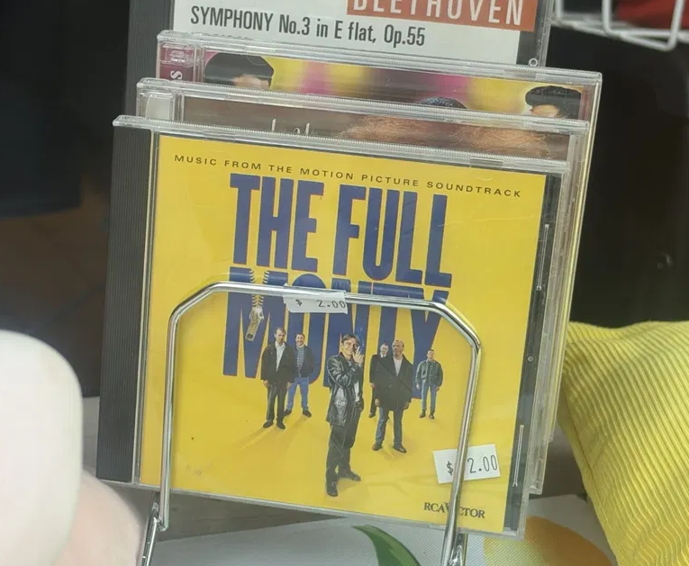 The Full Monty soundtrack CD priced at $2 in a rack at a Salvos store in South Melbourne